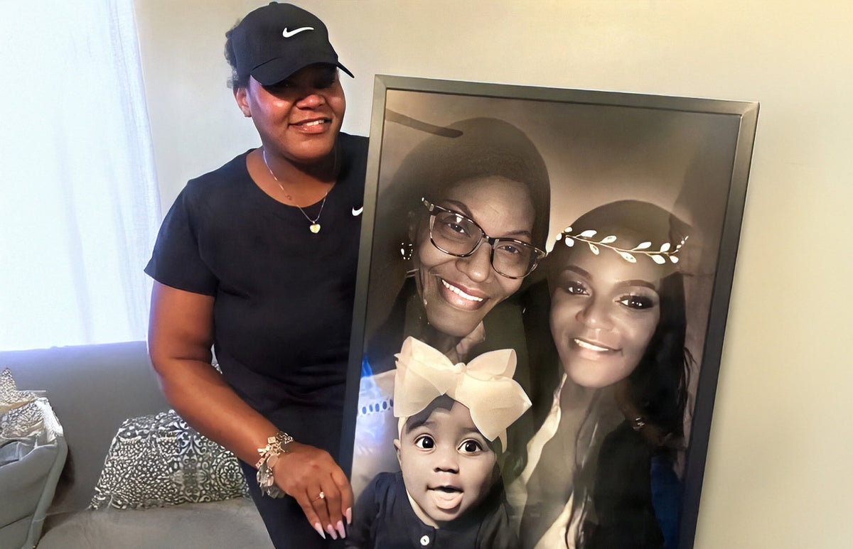 Woman smiling beside large framed family portrait gift with mom, daughter, and baby